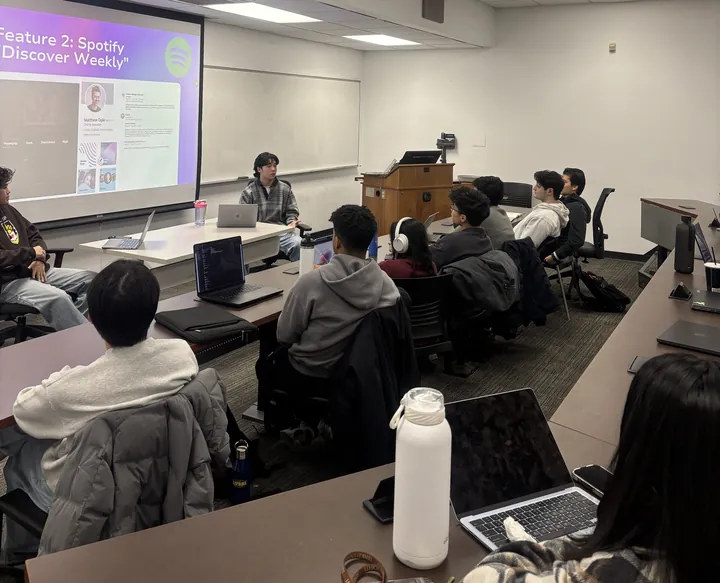 A member presenting a feature teardown at a weekly workshop