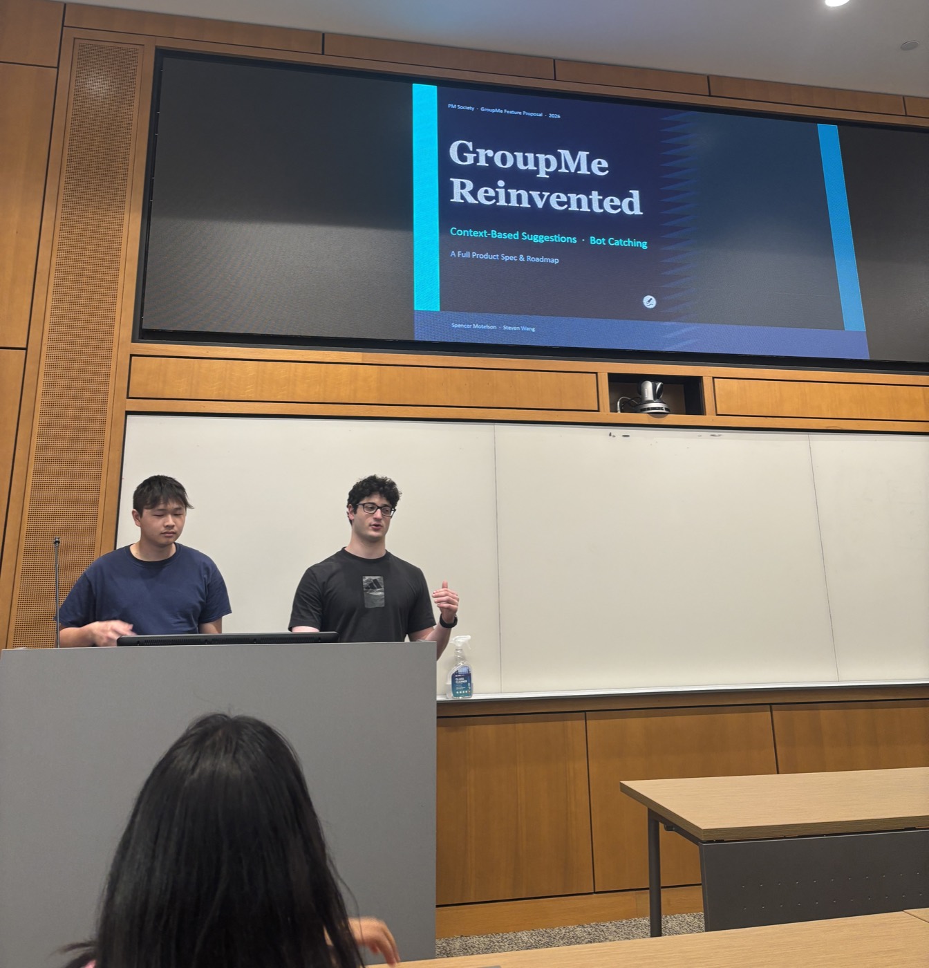 Two members pitching their product idea on stage
